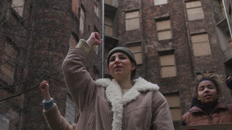 bottom view of  activists raising fists during a climate change protest in the street