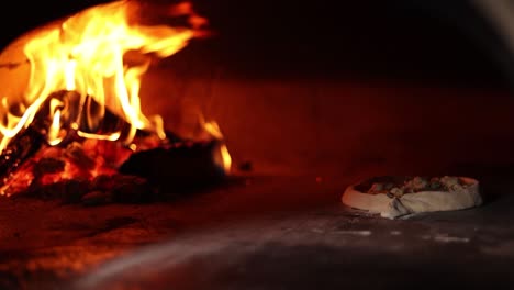 pizza baking in a wood-fired oven