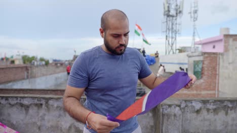 Indian-man-checking-the-kite-before-flying