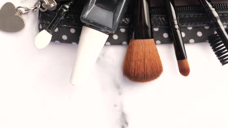 makeup brushes and nail polish in a makeup bag