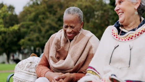 senior women on bench in park with laugh