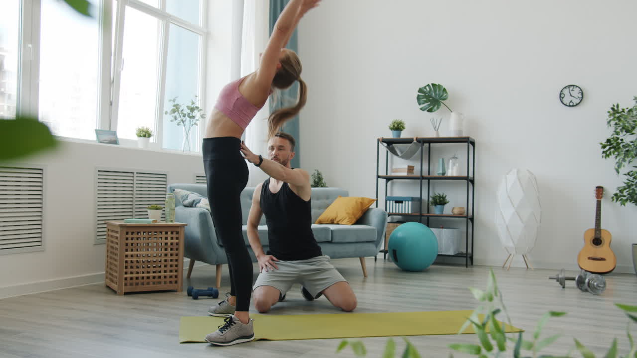 Couple doing backbend exercise at home