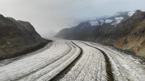 Aerial-flyover-over-the-longest-glacier-in-the-Alps---the-Aletsch-glacier-in-Valais,-Switzerland---with-backwards-motion