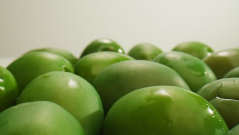 pickled round green olives from greece as background, top view. high quality 4k footage