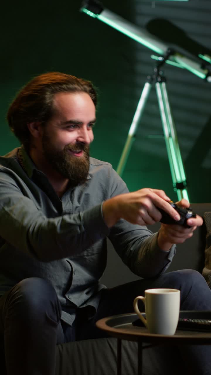 Vertical video Energic gamer jumping on couch, excited to start videogame