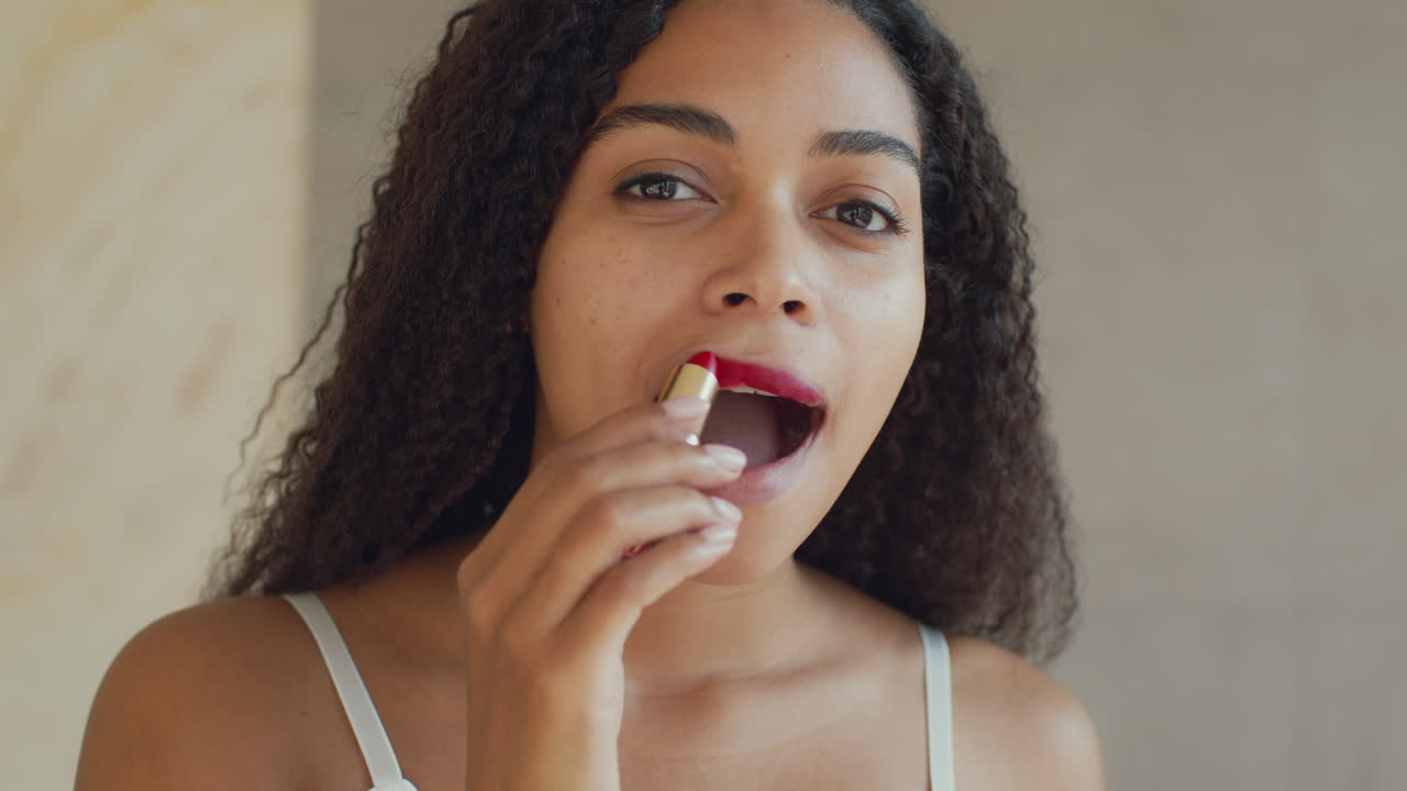 mujer aplicando lápiz labial