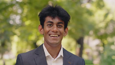 smiling surprised asian man in disbelief, medium shot outdoors