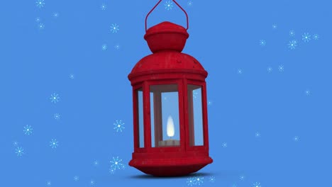 Animation-of-snow-falling-on-lantern-on-blue-background