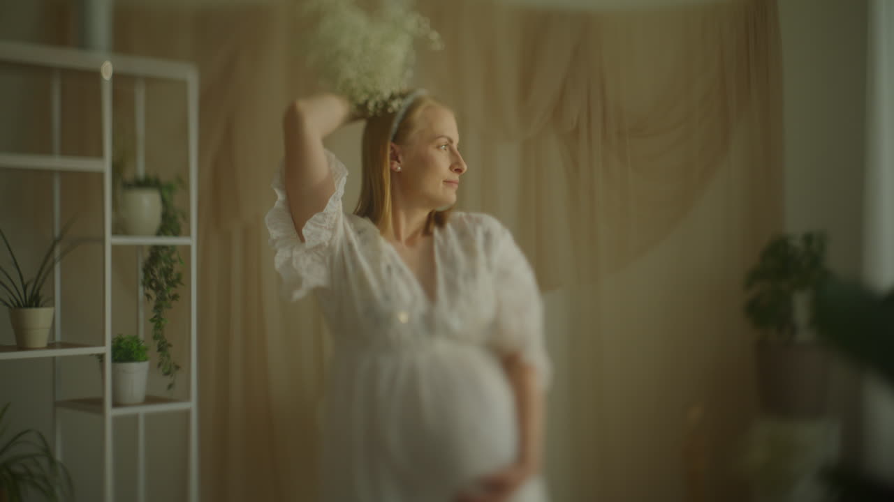 Pregnant Woman Posing with Gypsophila Bouquet