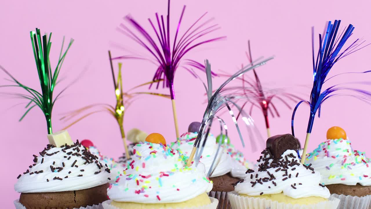 Delicious sweet cup cakes decorated for party on pink theme