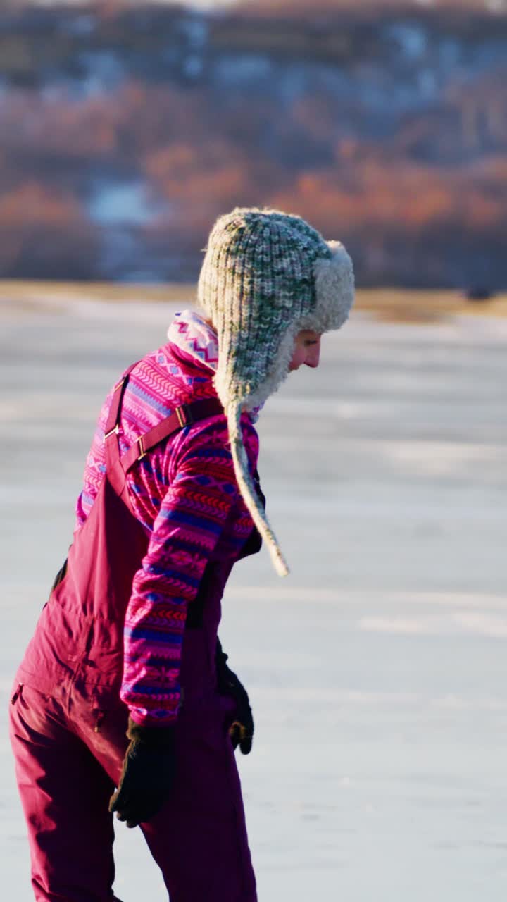 A joyful figure glides gracefully across a glistening frozen lake, embodying the spirit of winter recreation, wearing a colorful outfit adorned with striped patterns and a cozy hat, showcasing the beauty of outdoor ice skating