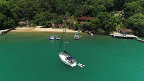 Calm-beach-with-boats,-rotational-view-of-drone-in-the-coastal-beach,-Empty-coastal-beach-with-boats-without-people