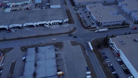 Busy-intersection-surrounded-by-warehouses-at-night