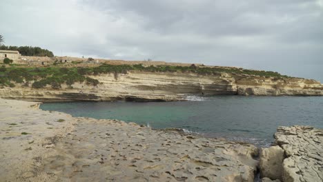 panorama of long and remote stone beach il-kalanka in malta