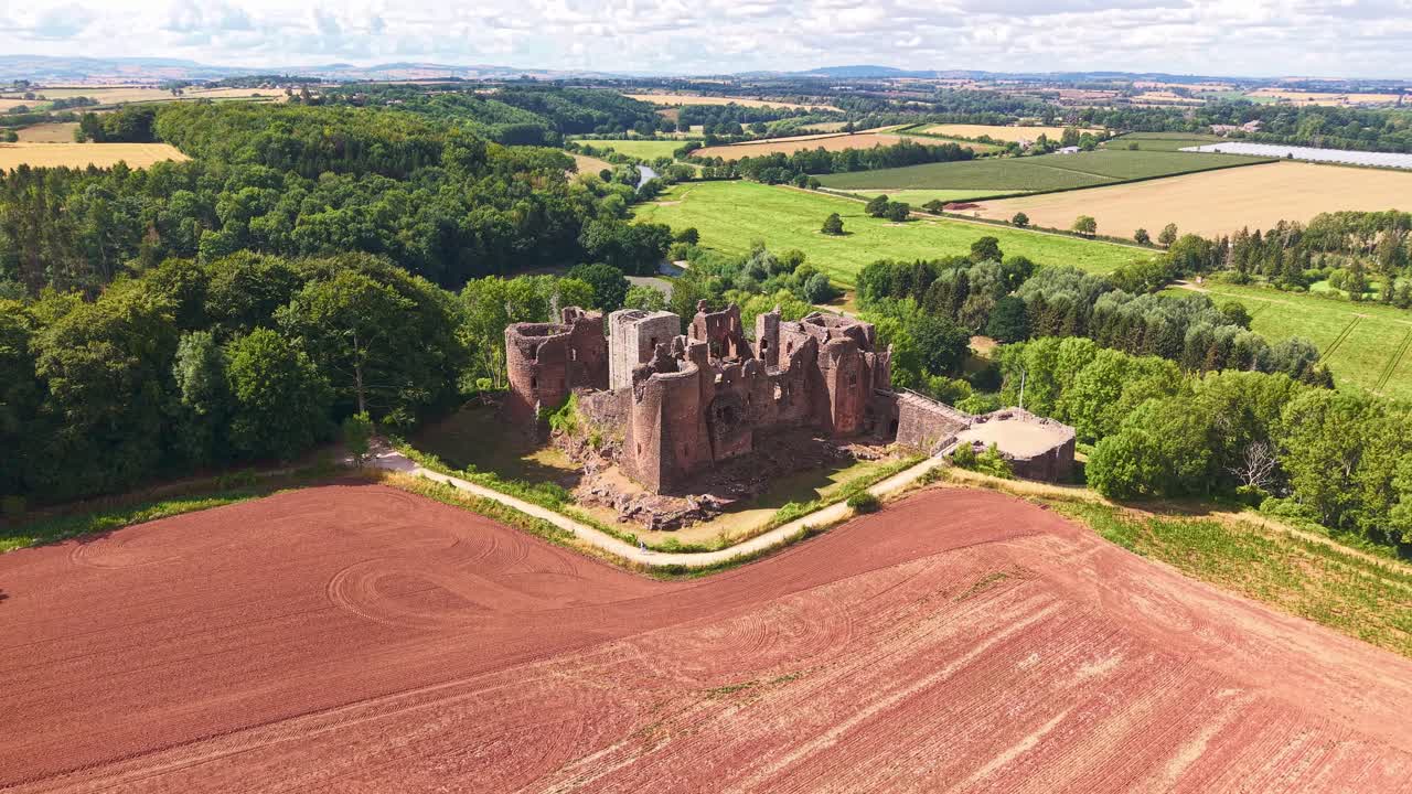 Aerial drone footage flying towards medieval Goodrich Castle ruins in Herefordshire