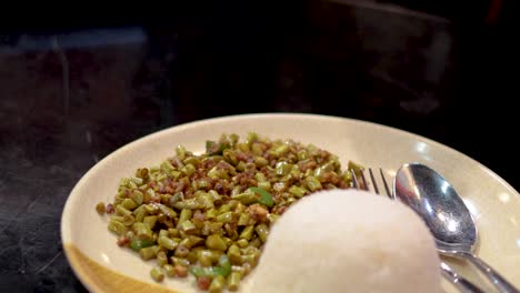 a plate of rice and vegetable meat dish