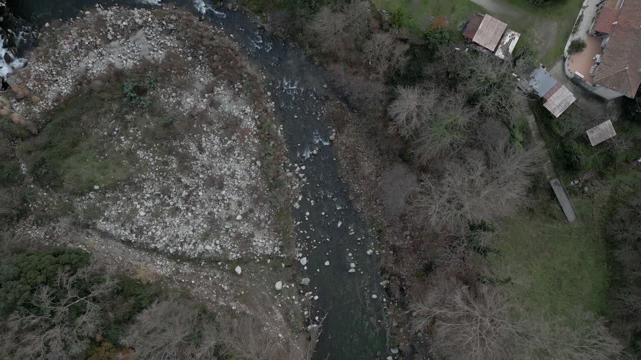 Winding river meandering through lush vegetation. Revealing serene landscape with rocky banks and flowing current near amelie les bains in french pyrenees mountain valley
