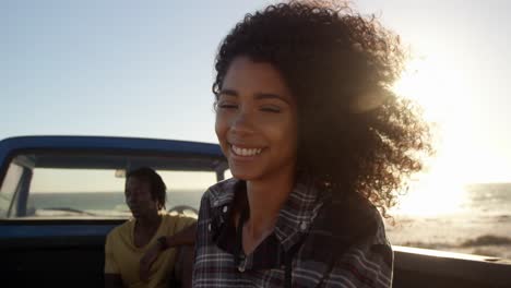 Woman-standing-near-pickup-truck-on-the-beach-4k