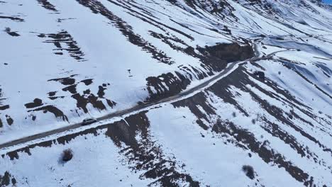 snowy mountain road with car