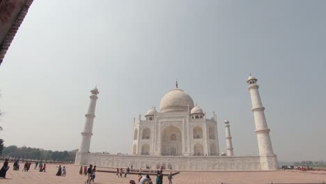 the taj mahal framed by one of the gates. approaching shot
