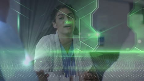 Green-spots-of-light-and-abstract-shapes-against-biracial-female-scientist-talking-at-a-laboratory