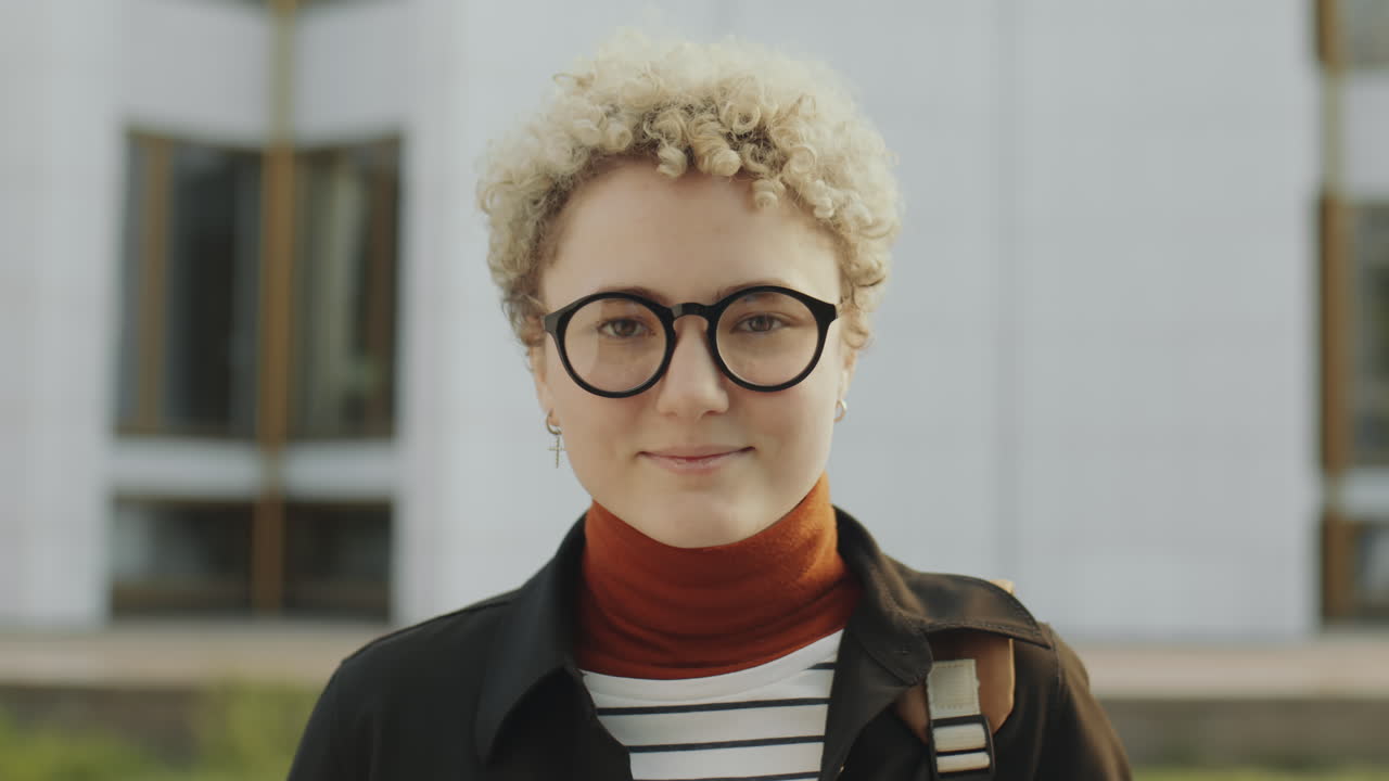 Portrait of a Young Woman with Curly Blonde Hair and Glasses