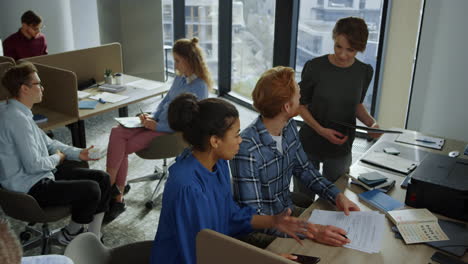 managers discussing financial report on documents. coworkers talking in office