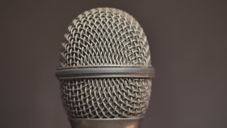 Extreme-closeup-of-old-dirty-stereo-microphone-head,-spinning