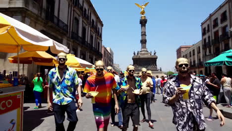 people in skull masks celebrating at a street market