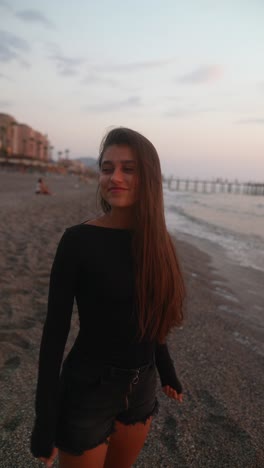 young woman at the beach at sunset