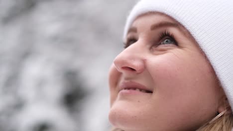 the face of a happy woman in a snowy forest she enjoys a beautiful winter day the face of a happy woman in a snowy forest she enjoys a beautiful winter day winter concept