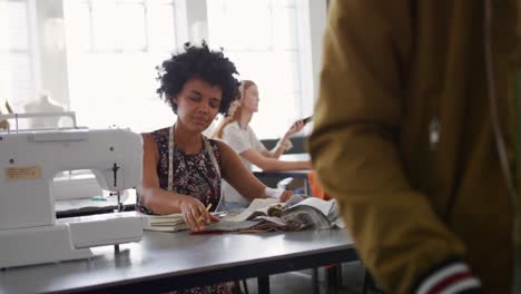 mixed race woman working in fashion office