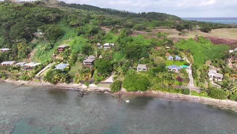 drone panoramic of hotel and houses in vanua levu, tropical island of fiji in pacific ocean.
