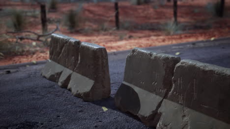 road barriers on a dusty desert road