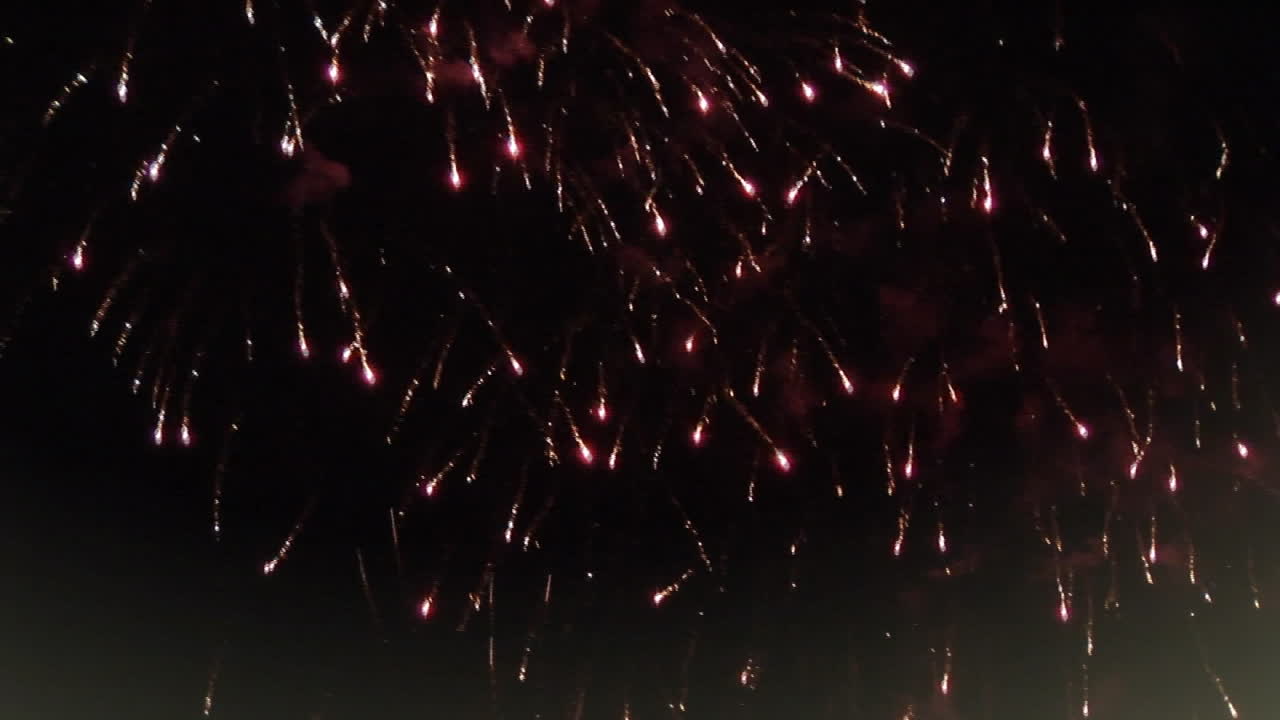 크리스마스 장식과 창문 프레임은 검은 배경에 불꽃놀이가 터지고 있습니다.