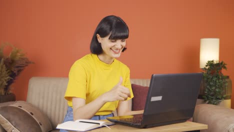 Woman-looking-at-laptop-making-positive-gesture.