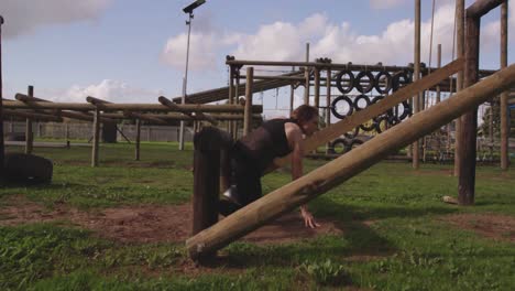 young woman training at an outdoor gym bootcamp