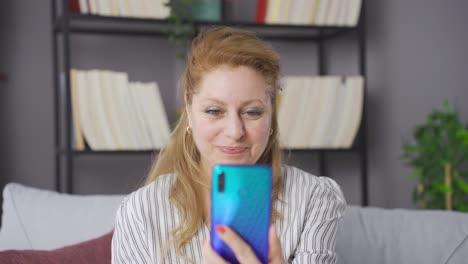 Mature-elderly-mother-video-chatting-with-her-children-on-the-phone.