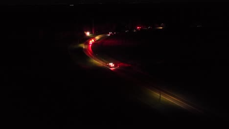 aerial establishing shot of car accident on american highway at night. flashing red lights of fire truck,arriving crash site on road. aerial wide shot. dangerous traffic scene in usa. call 911 and 112