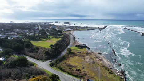 beautiful 4k aerial drone shot showcasing homes and sea in bandon, oregon