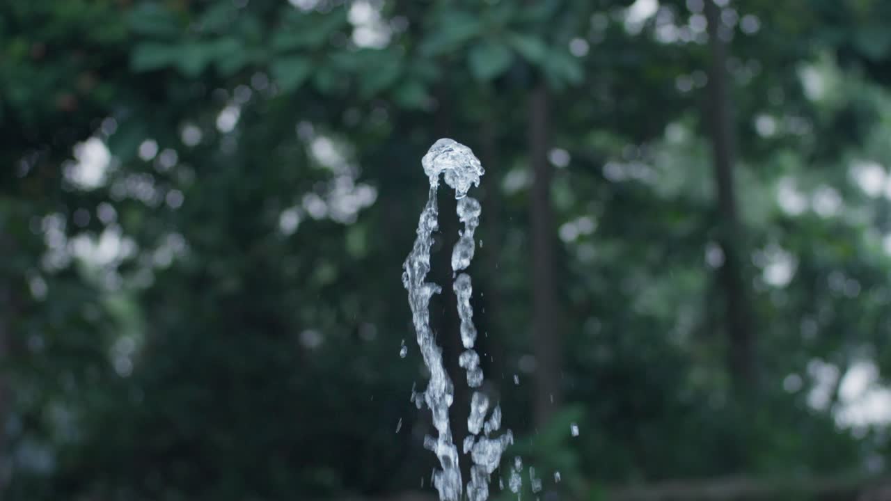 Outdoor Water Fountain Spraying Up In Slow Motion.