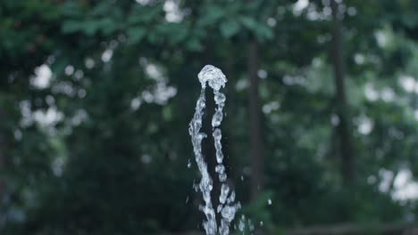 outdoor water fountain spraying up in slow motion.