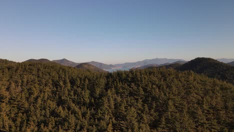 Drone-shot-flying-over-forests-and-mountains-in-Namhae-County,-South-Korea