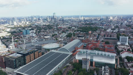 Slide-and-pan-view-of-St-Pancras-train-station.-Aerial-panoramic-view-of-city-with-group-of-tall-modern-skyscrapers-in-distance.-London,-UK