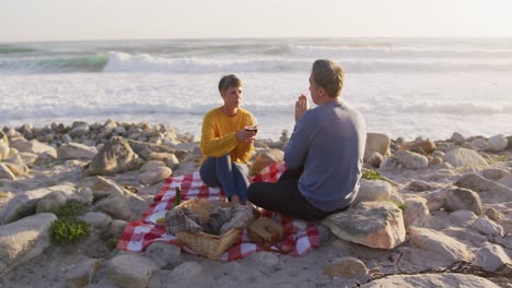 couple drinking wine by the sea