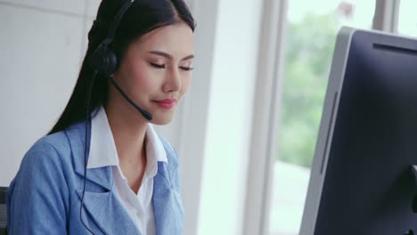 customer support agent or call center with headset talking to customer on phone.