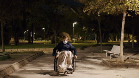 handicapped boy in wheelchair in the park in late evening