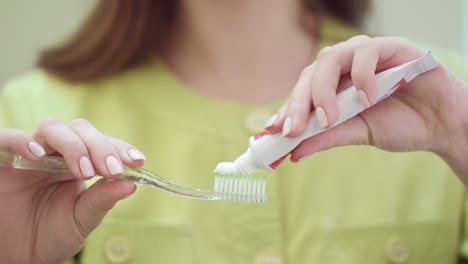 doctor hands squeezing toothpaste on toothbrush. morning teeth care concept