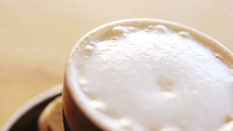 Close-up-of-creamy-coffee-on-wooden-table