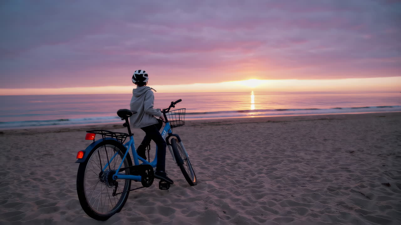 Young Boy on Bicycle at Beach Sunset